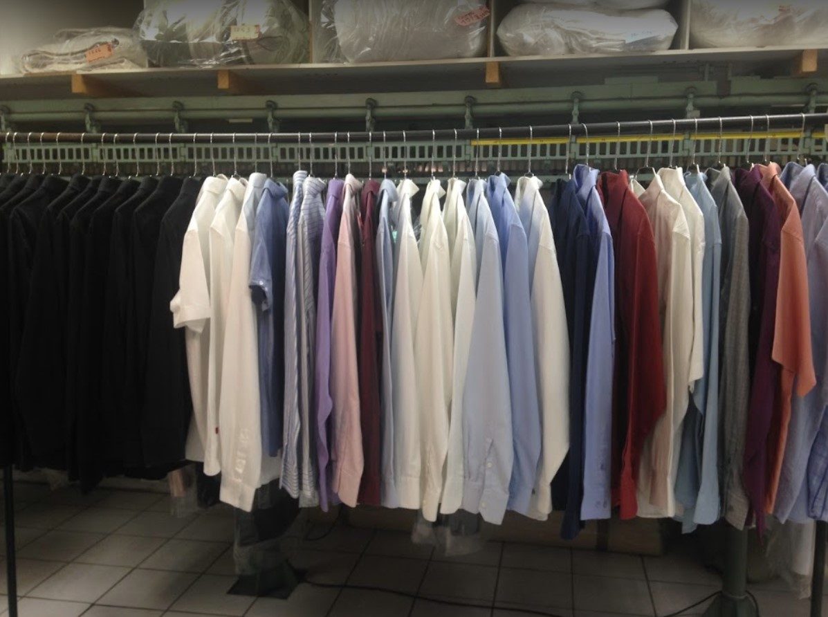 Shirts cleaned and ironed on a rack, in the Pressing Vite Propre workshop in Bordeaux